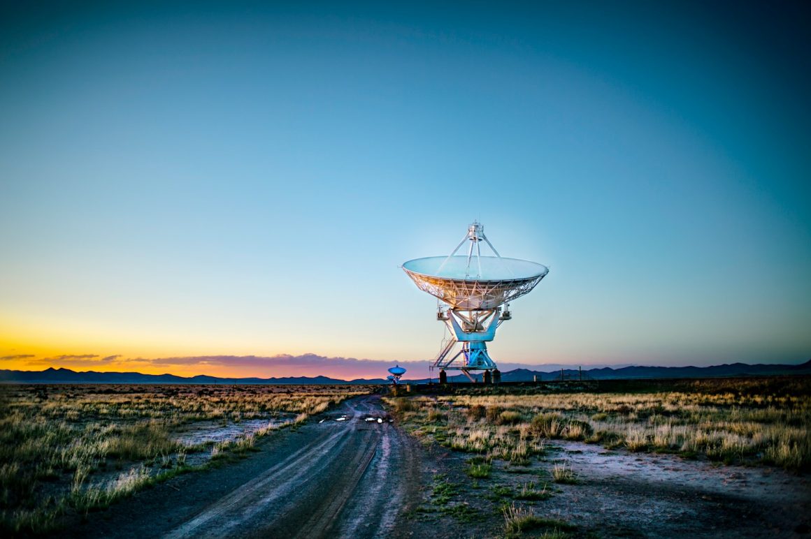 Photo by Donald Giannatti white radar telescope on grass field