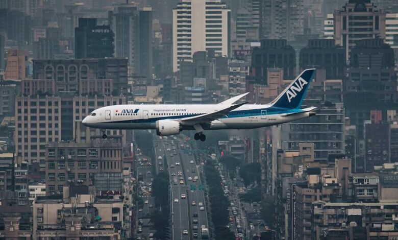 white airplane flying over city during night time