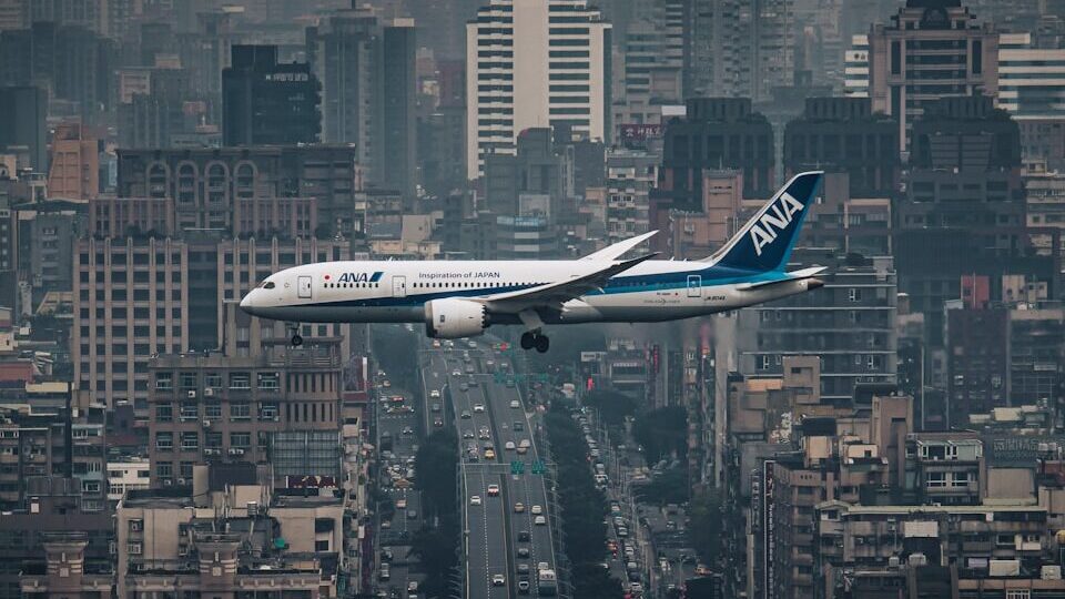 white airplane flying over city during night time